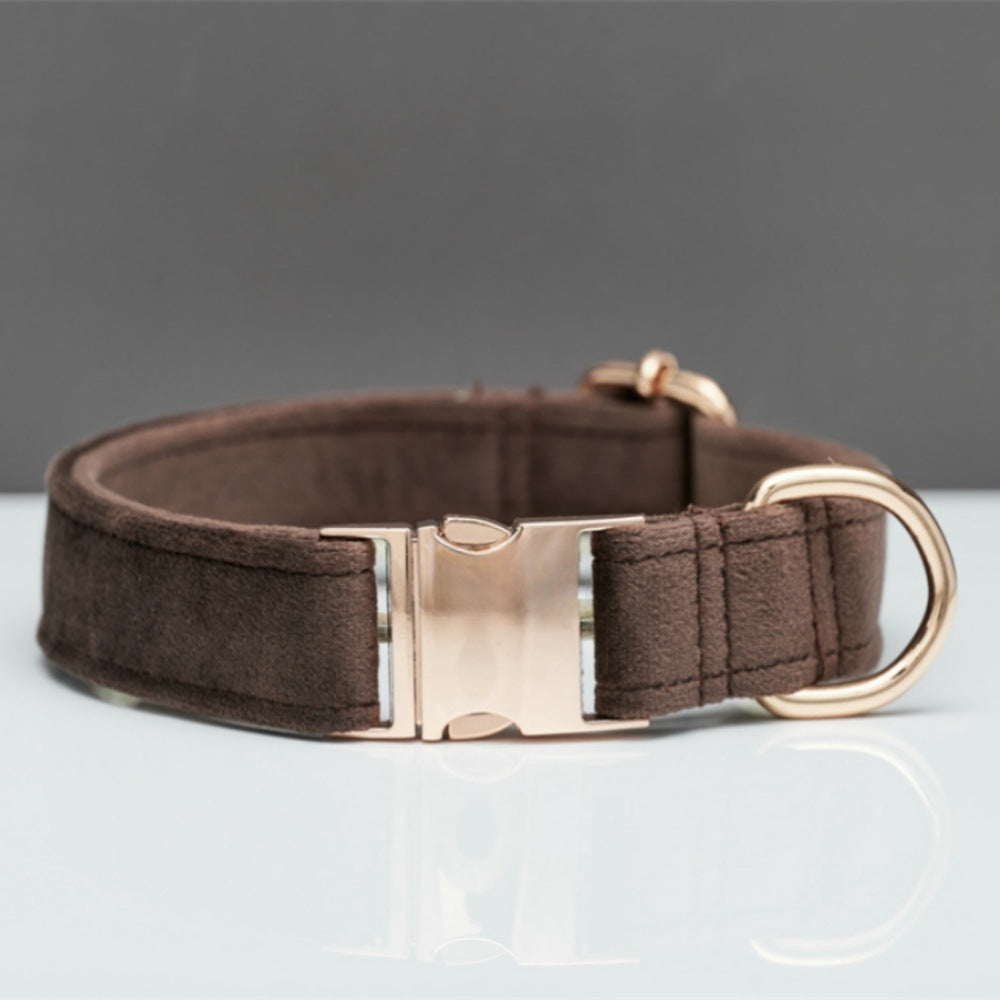 Brown dog collar with a rose gold buckle on a gray background