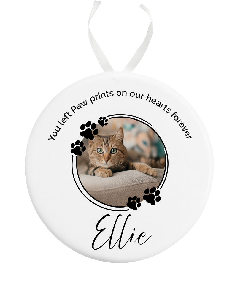 Round ceramic ornament with a photo of a cat named Ellie and text on a white background