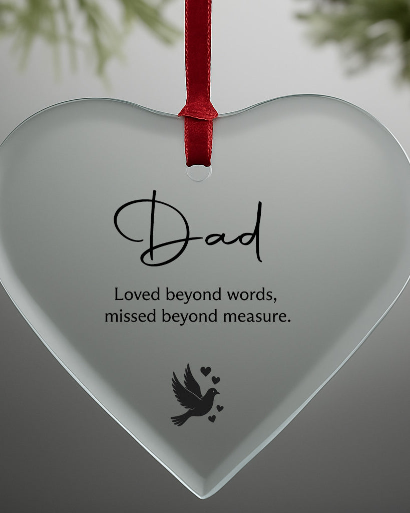 Heart-shaped glass ornament with 'Dad' and a quote on a gray background
