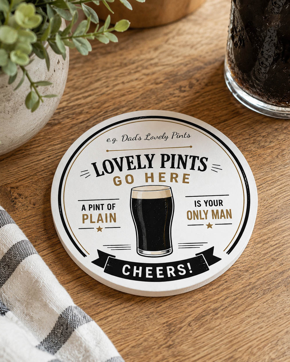 Round personalised ceramic coaster with a glass of beer and text on a white background