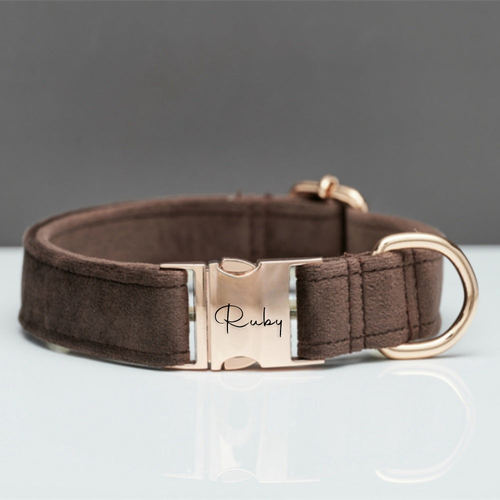 Brown dog collar with rose gold buckle on a gray background