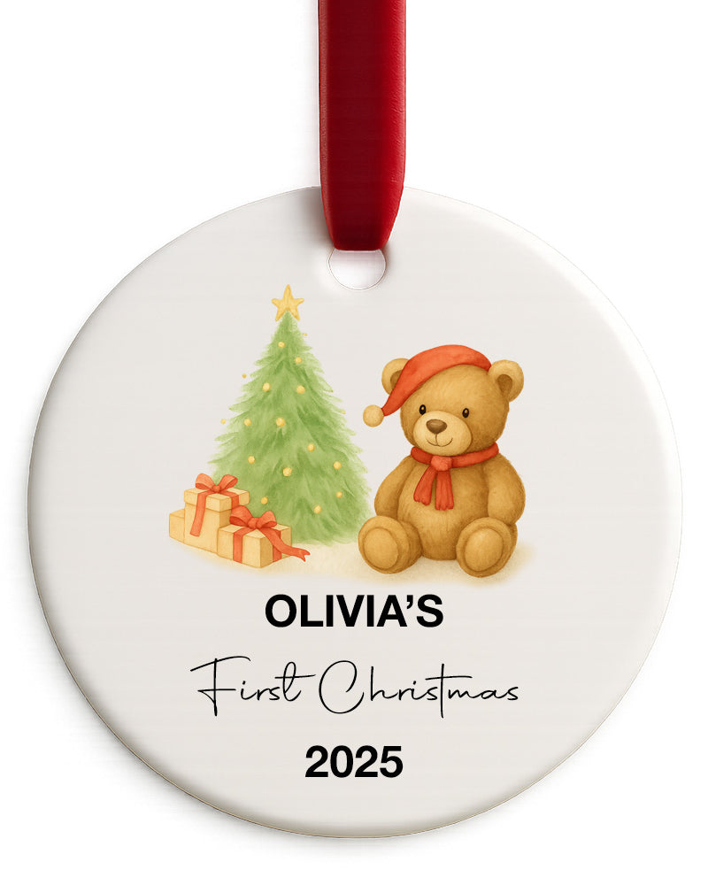 Round Christmas ornament with a teddy bear, tree, and presents, personalized for 'Olivia's First Christmas 2025'.