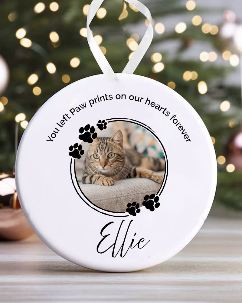 Round ceramic ornament with a photo of a cat named Ellie and text on a white background