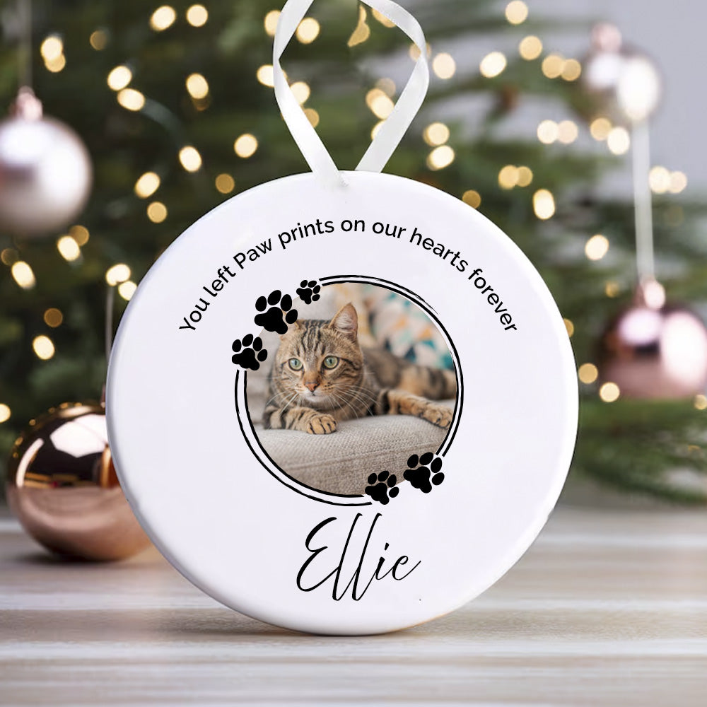 Round ceramic ornament with a photo of a cat named Ellie and text on a white background