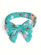 Teal dog collar with a bow tie featuring holly and snowflake patterns on a white background