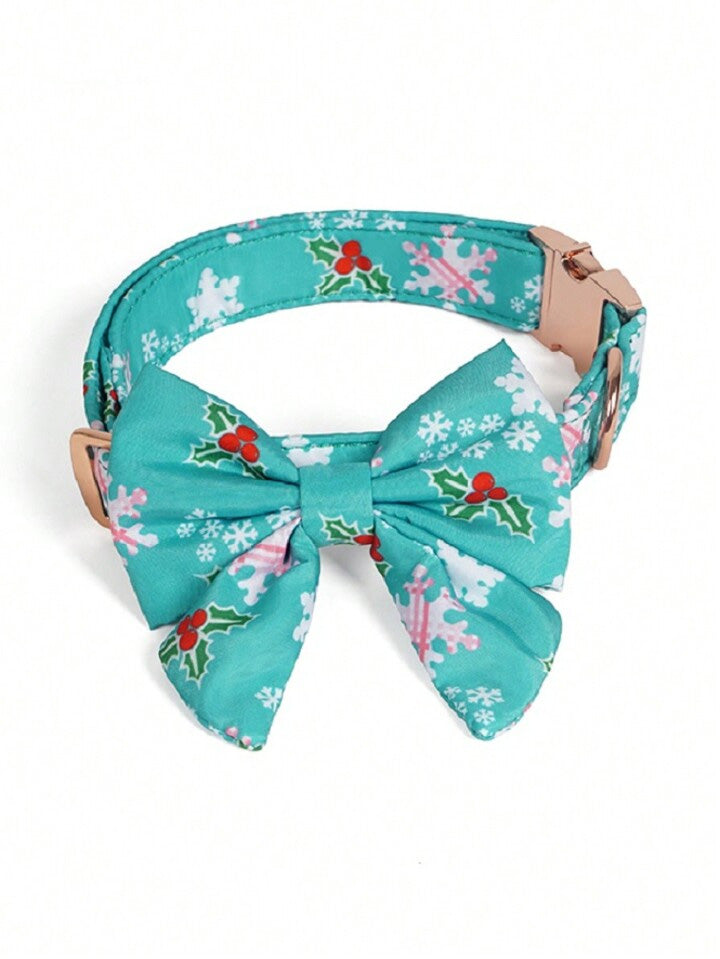 Teal dog collar with a bow tie featuring holly and snowflake patterns on a white background