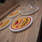 Coasters with 'Ryan's Cocktails' logo on a wooden surface