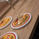 Glass of champagne on a coaster with a brand logo on a wooden surface
