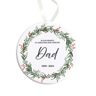 Round Christmas ornament with greenery design and text 'Dad' and year range on a white background