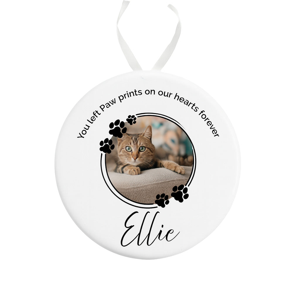 Round ceramic ornament with a photo of a cat named Ellie and text on a white background