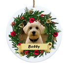 Decorative Christmas ornament with a dog's face surrounded by a wreath and the name 'Bobby'.