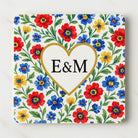 Decorative cpoasterwith floral pattern and 'E&M' initials